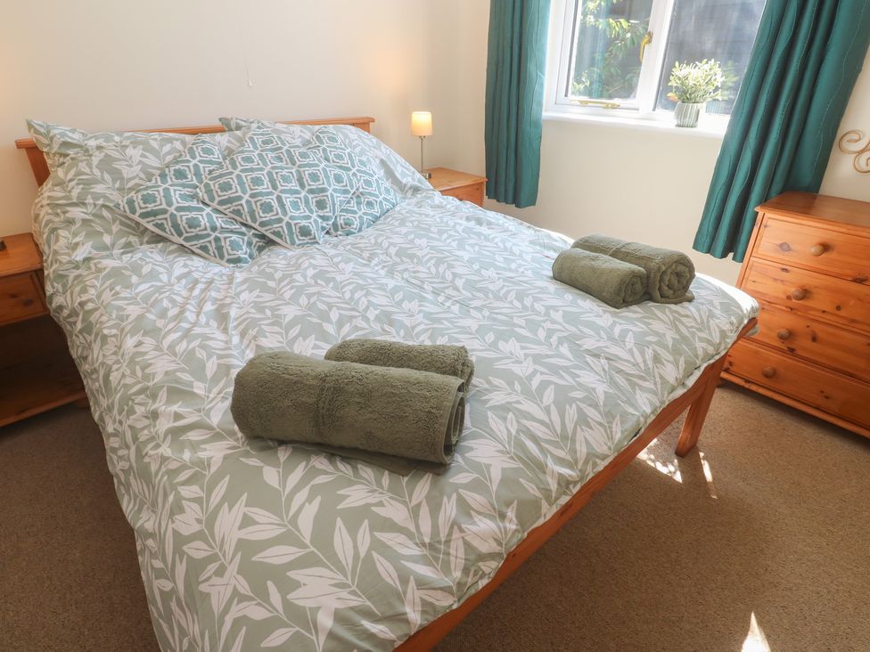A bedroom with a bed and pillows at Stargazy in Falmouth