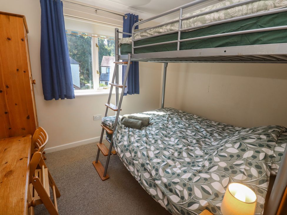 A bedroom with a bunk bed and a desk at Stargazy in Falmouth