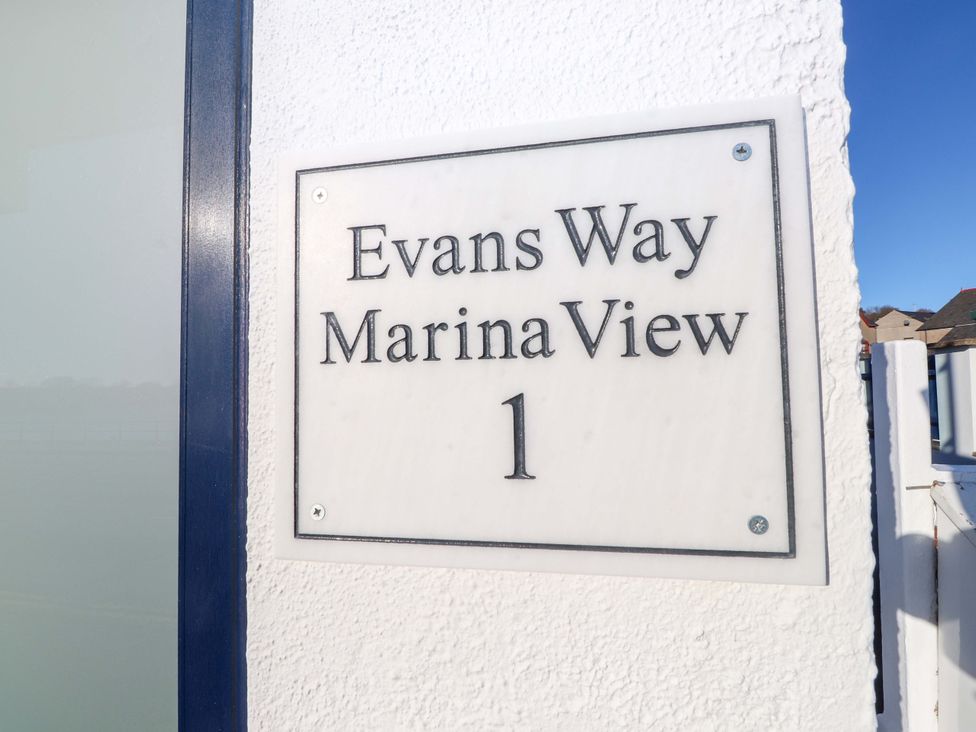 An address nameplate for Evans Way Marina View 1 in Pwllheli