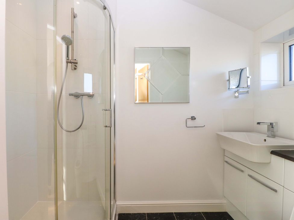 A bathroom with a shower and sink at 1 Marina View Pwllheli