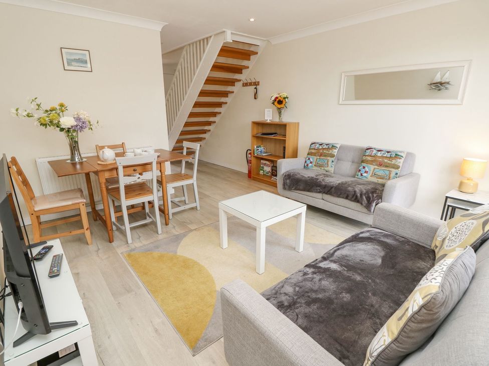 A living room with furniture including sofas and a dining table at Harbour View Poole