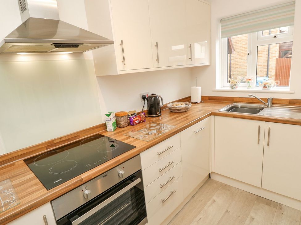 A kitchen with kettle, oven and sink at Harbour View Poole