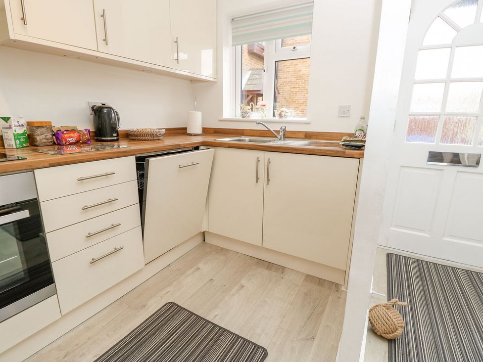 A kitchen with a sink and kettle at Harbour View Poole