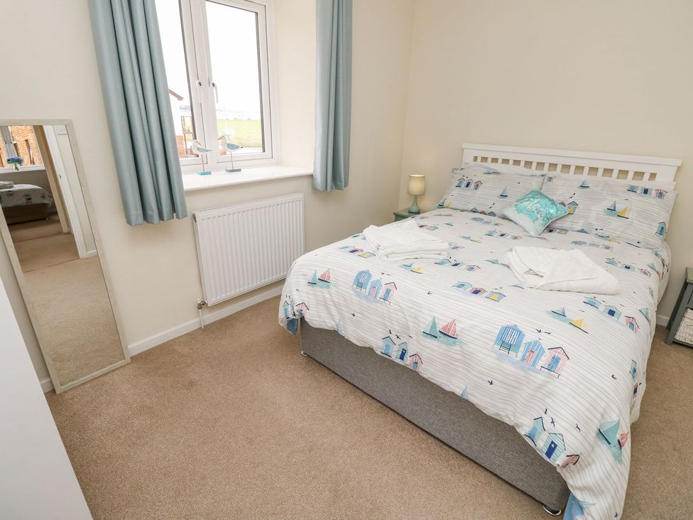 A bedroom with a bed and window at Harbour View Poole