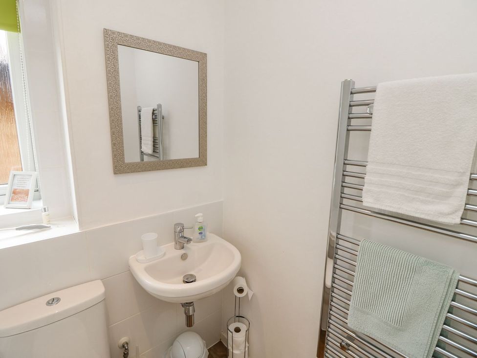 A bathroom with a sink and toilet at Harbour View Poole in Poole