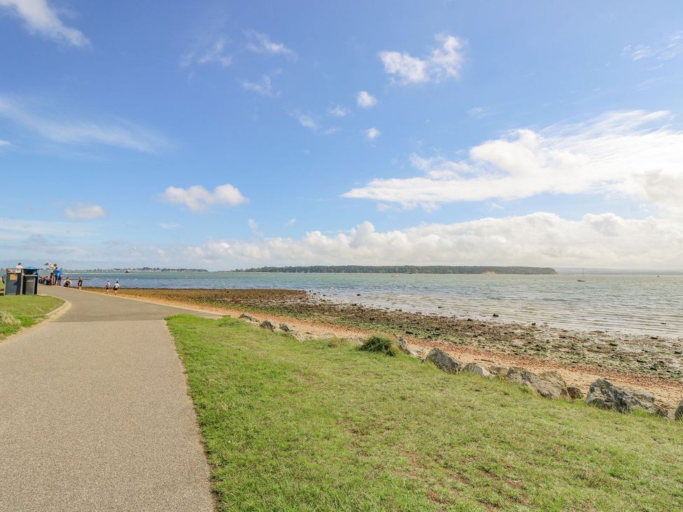 A pathway by the water with people at Harbour View Poole in Poole