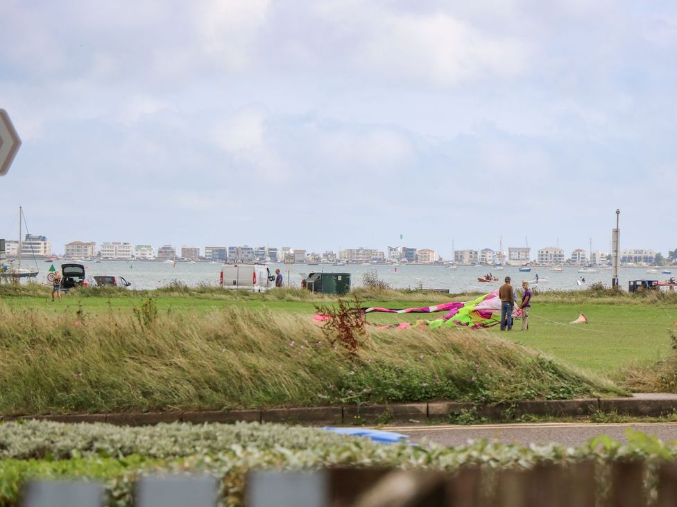 A view of the waterfront with people and boats at Harbour View Poole in Poole