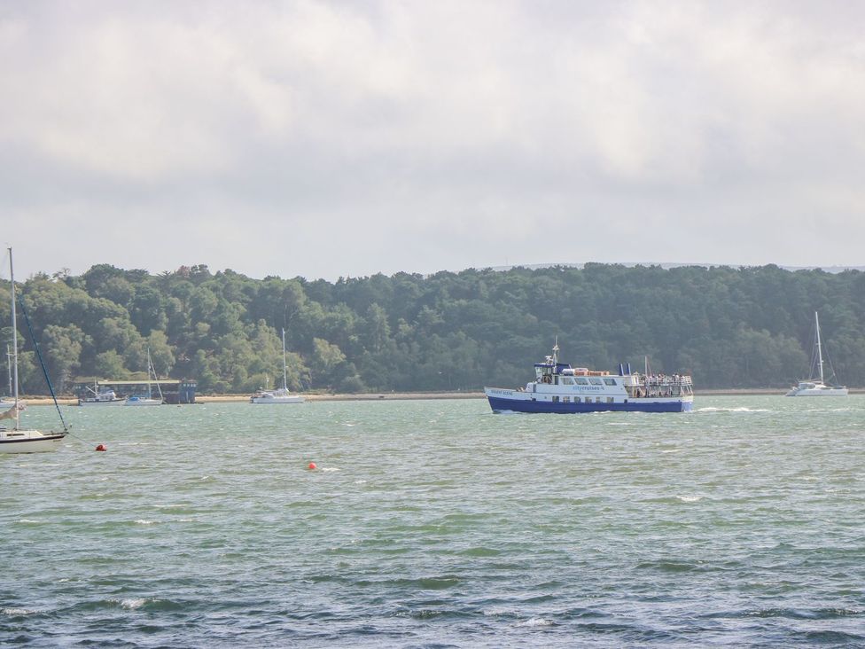 A boat on water with trees in the background at Harbour View Poole