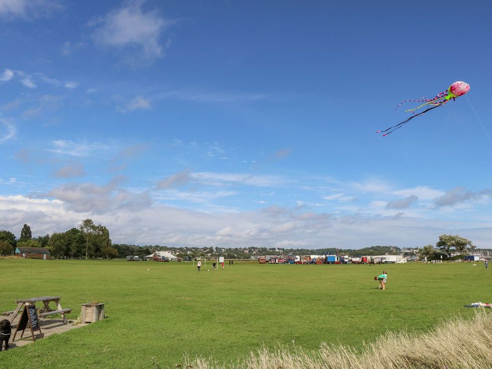 A field with a kite flying and people in the distance at Harbour View Poole