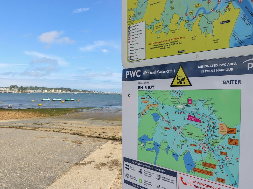 A map and sign near the water showing a personal watercraft area at Harbour View Poole