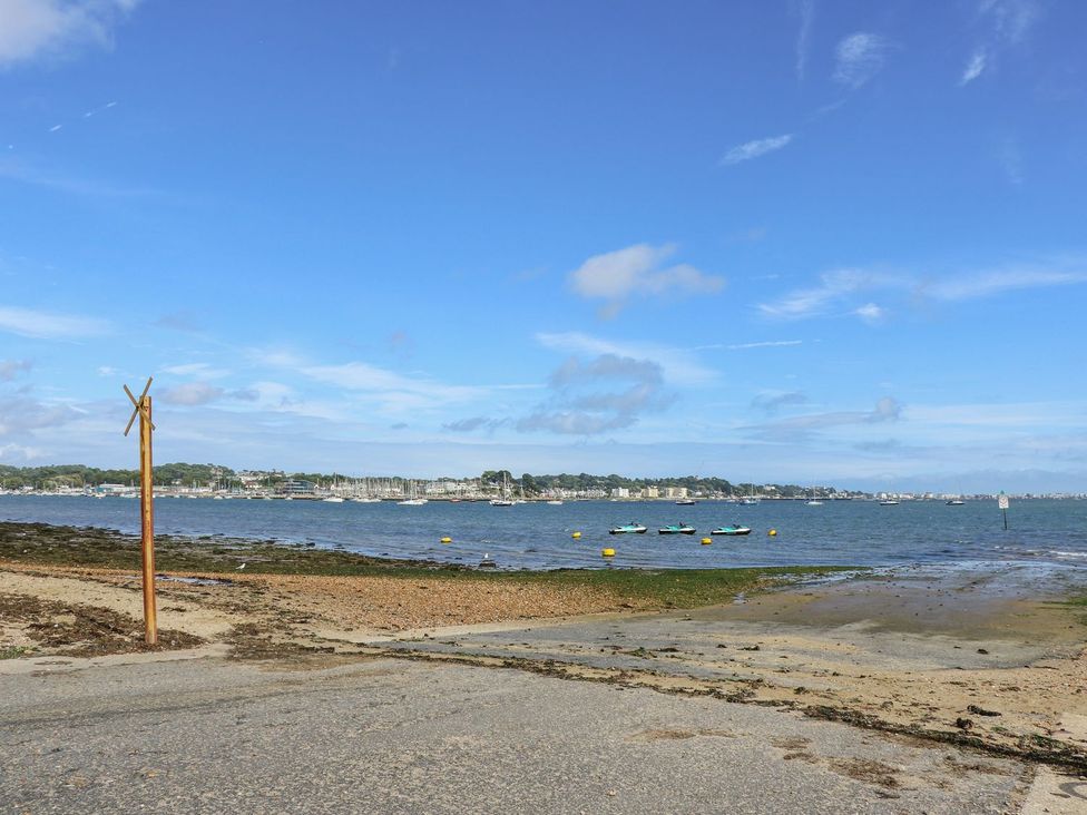 A beach with boats on water at Harbour View Poole