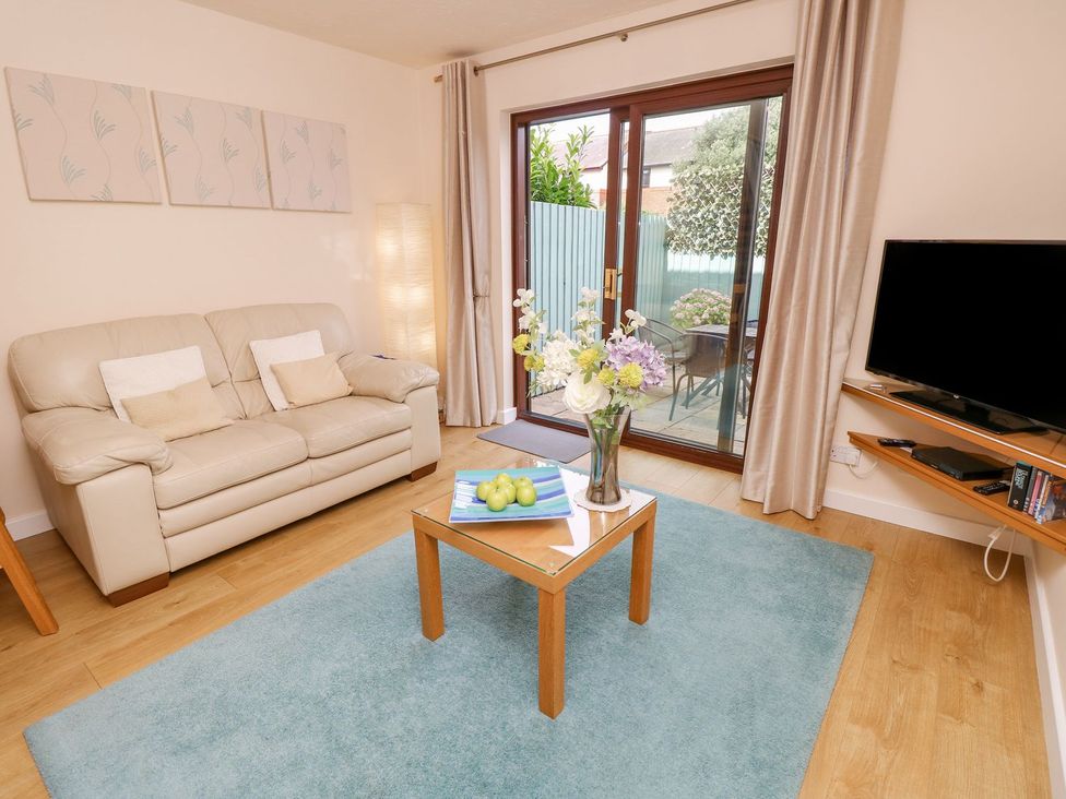 A living room with a sofa and a coffee table at Poole Quay Cottage in Poole