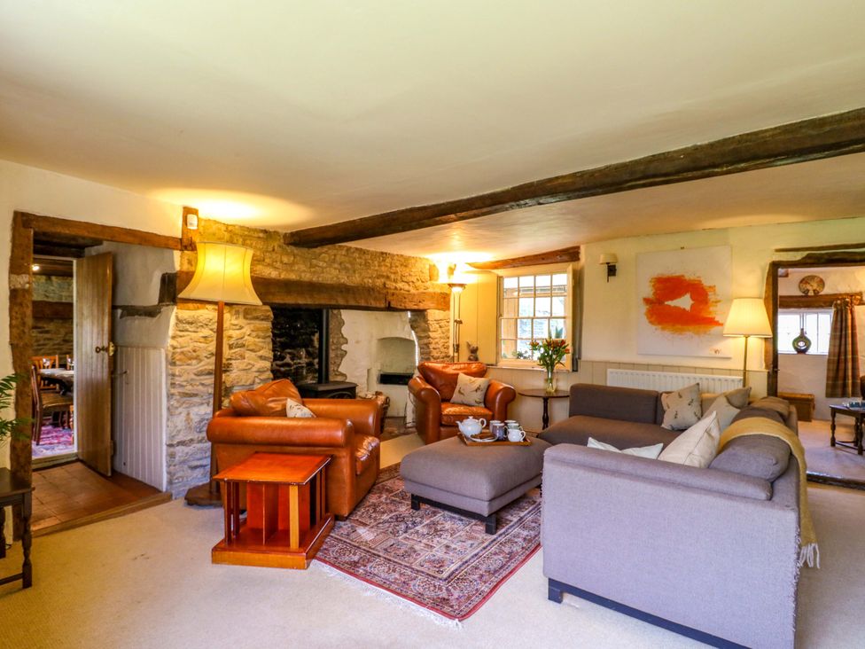A living room with sofas and a fireplace at Manor Farm Cottages, Loughton, Milton Keynes