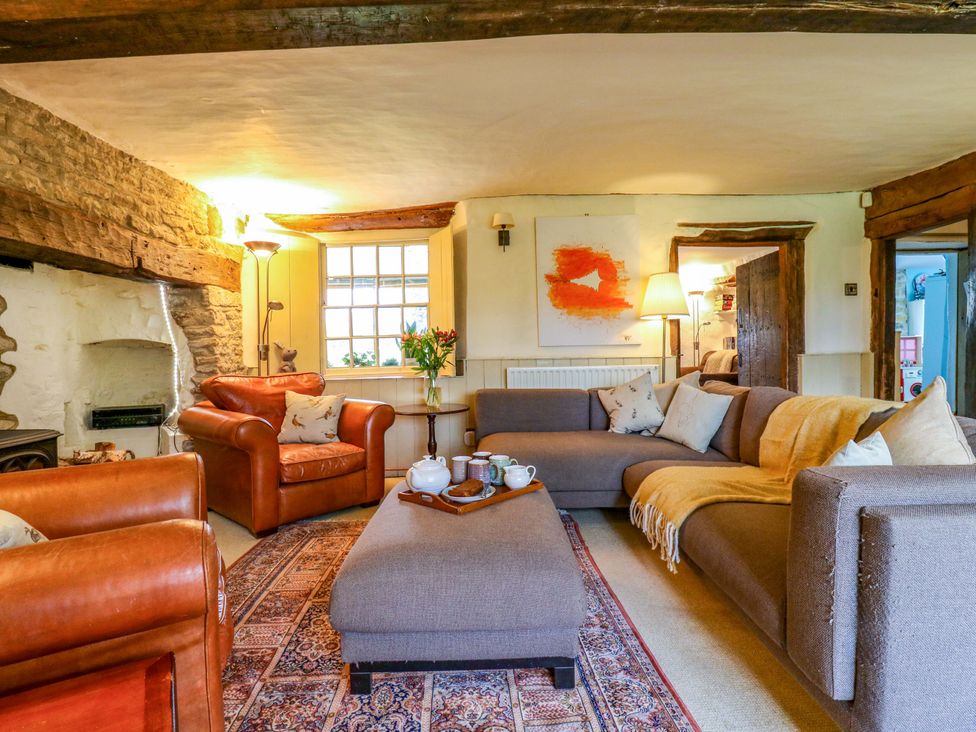 A living room with sofas and a coffee table at Manor Farm Cottages, Loughton, Milton Keynes