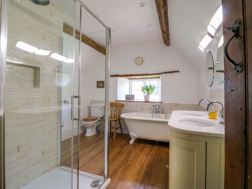 A bathroom with a shower and bathtub at Manor Farm Cottages in Loughton, Milton Keynes