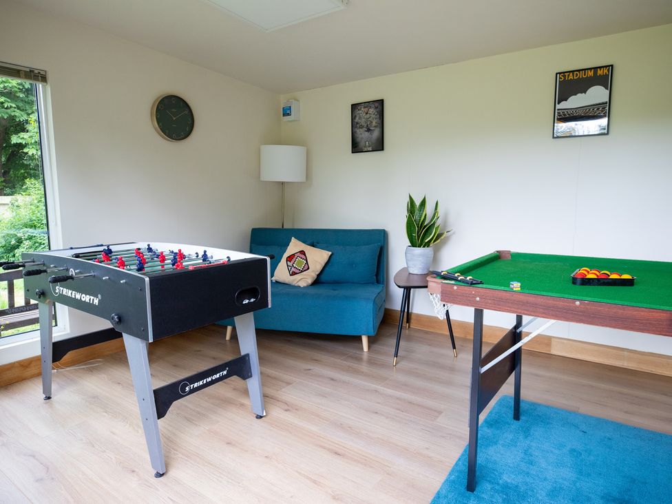 A snug with foosball and pool tables at Manor Farm Cottages, Loughton, Milton Keynes