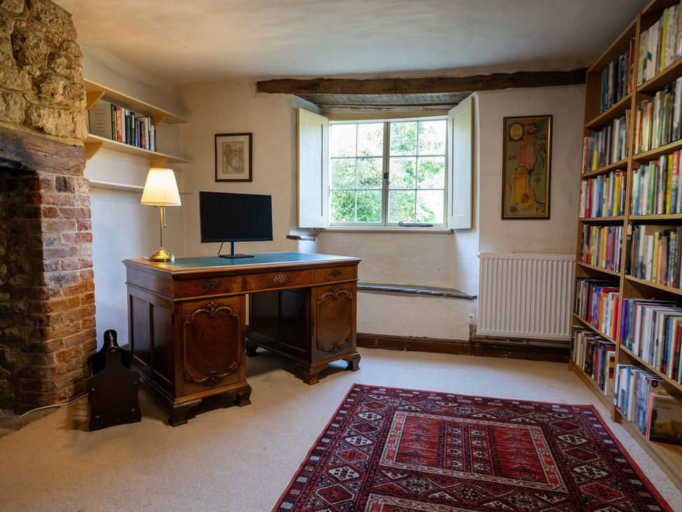 A study with a desk and bookshelf at Manor Farm Cottages, Loughton, Milton Keynes
