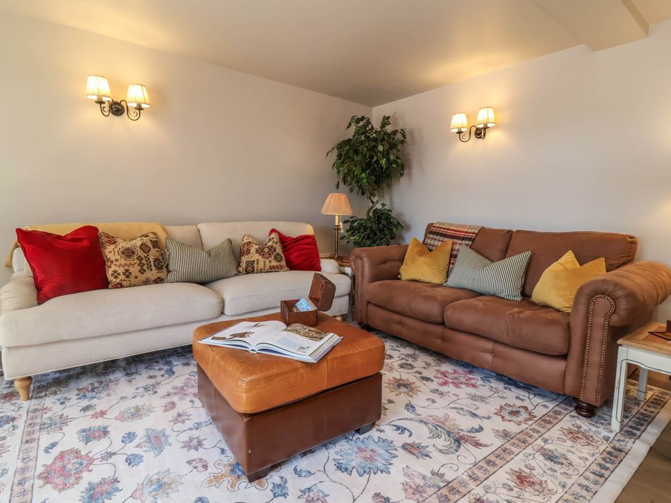 A living room with two sofas and a coffee table at Captains Barn Tiverton