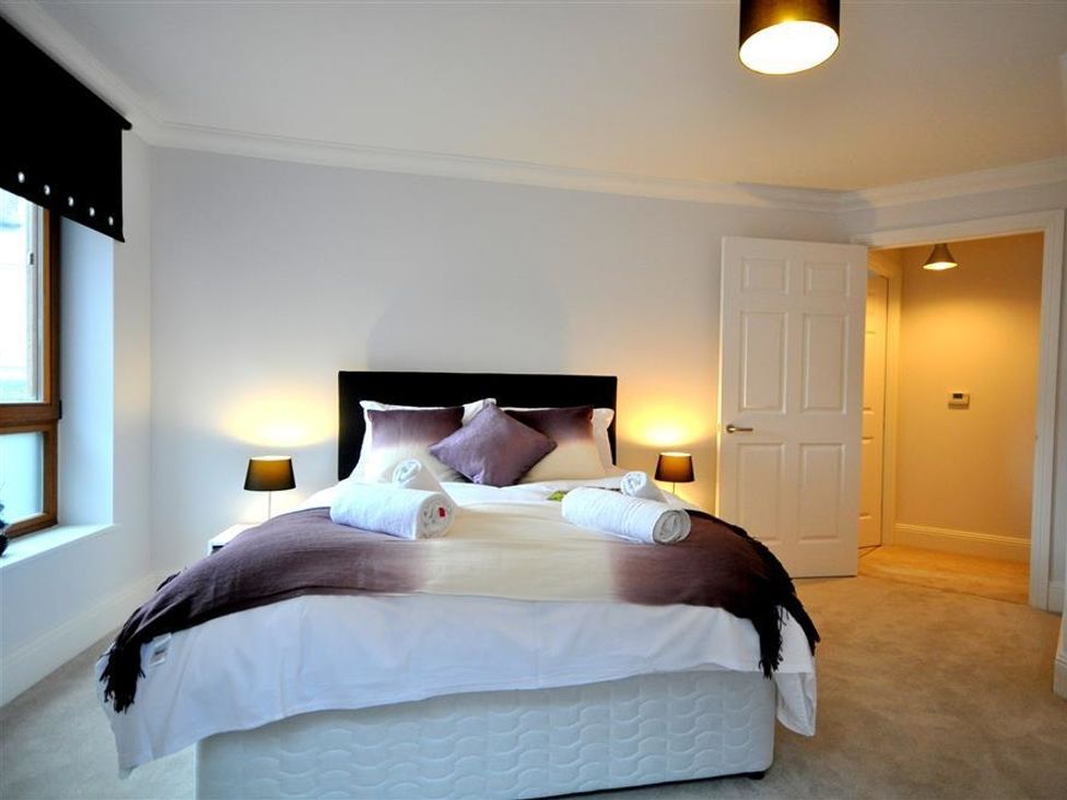 A bedroom with a bed and bedside lamps at Old Harbour View, Weymouth