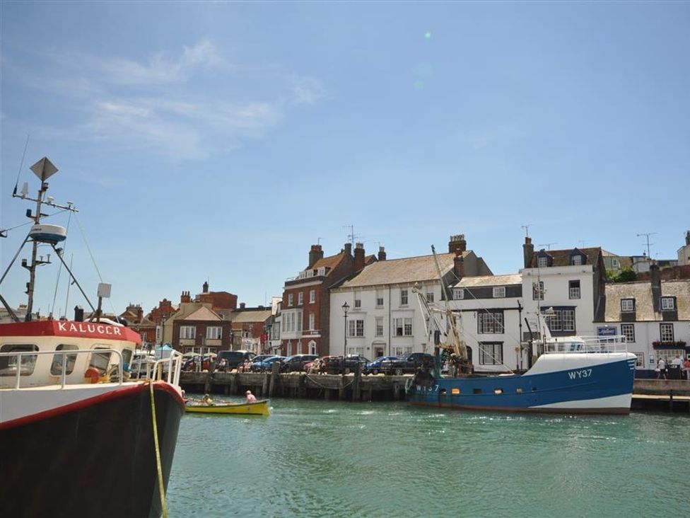 A harbor with boats and buildings at Old Harbour View in Weymouth