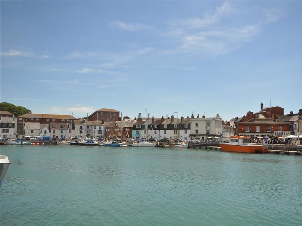 A harbor with boats and buildings at Old Harbour View in Weymouth
