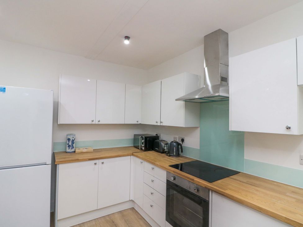 A kitchen with appliances and cabinets at Beachwalk Villa 2 in Whitby