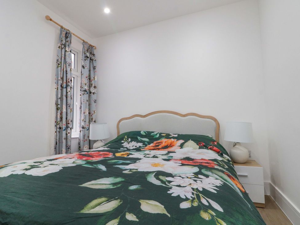 A bedroom with a bed and lamps at Beachwalk Villa 2 in Whitby