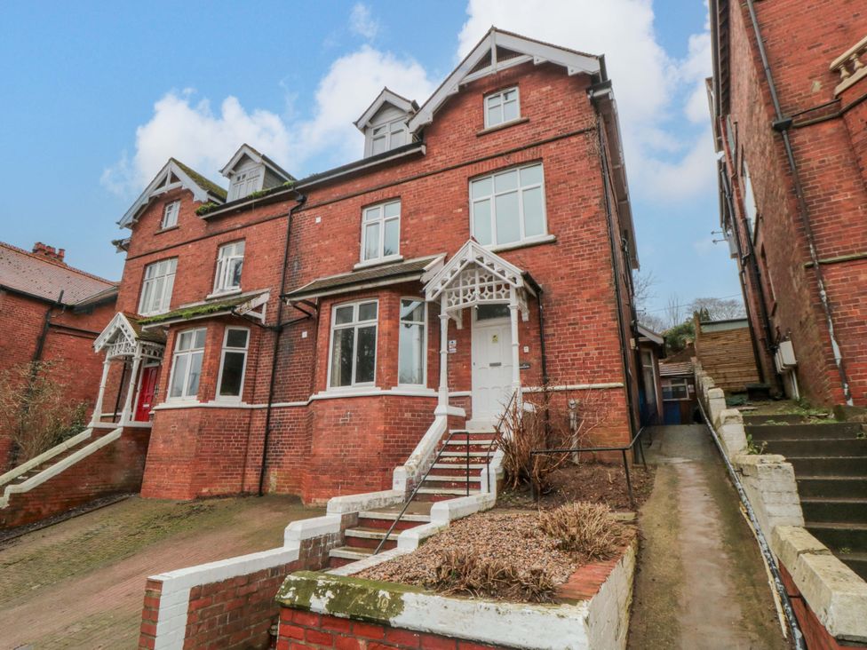A brick house with stairs and a pathway at Beachwalk Villa 2 in Whitby