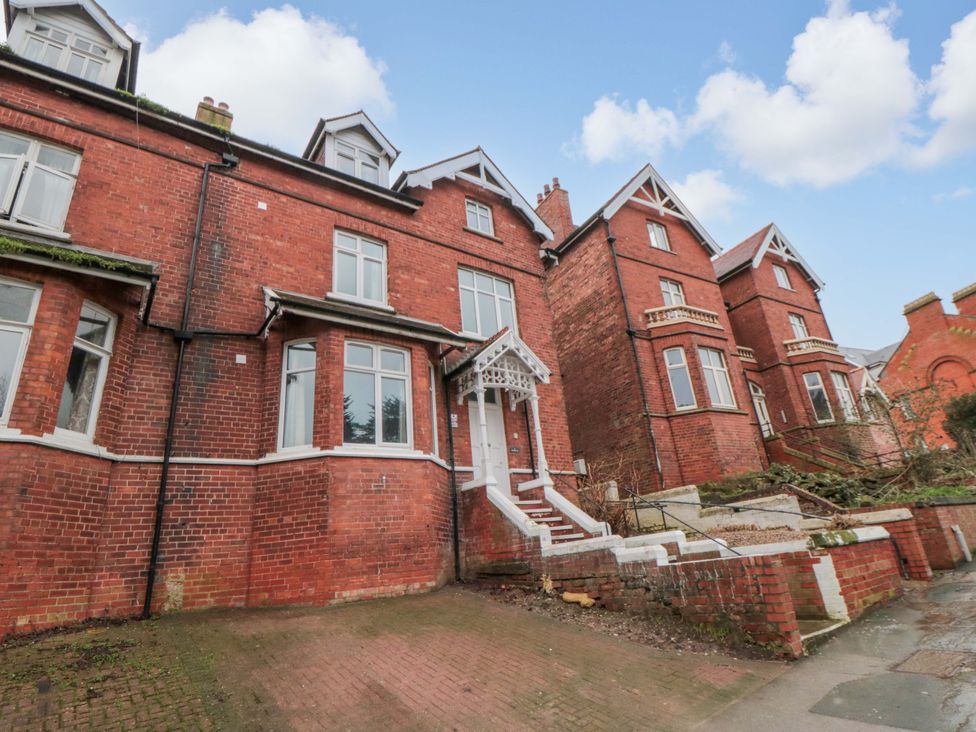 An exterior view of a brick house with steps at Beachwalk Villa 2 in Whitby