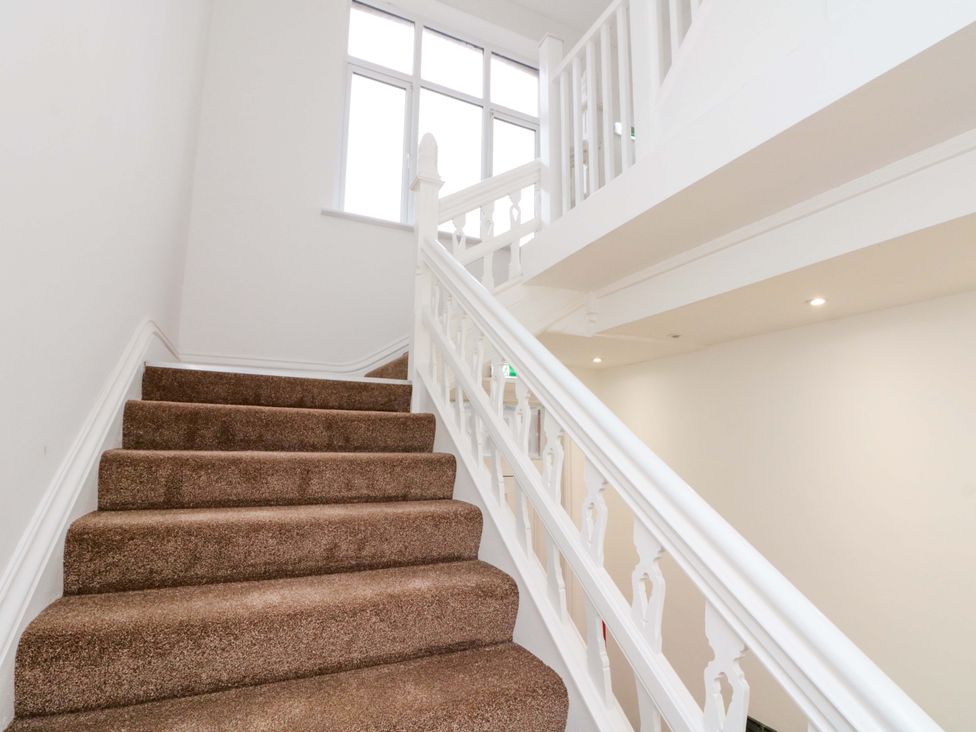 A staircase with a handrail leading upwards at Beachwalk Villa 3 in Whitby