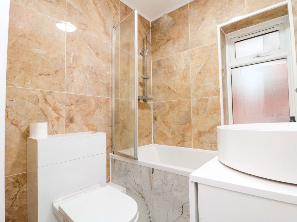 A bathroom with a bathtub and shower at Beachwalk Villa 3 in Whitby