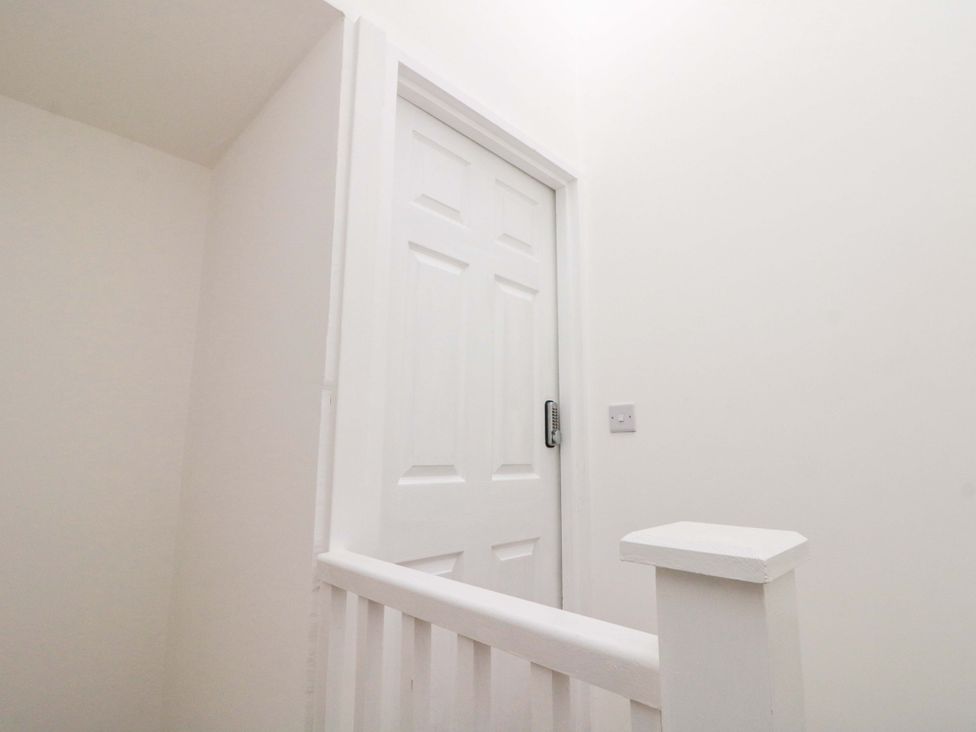 A staircase with a door at Beachwalk Villa 3 in Whitby