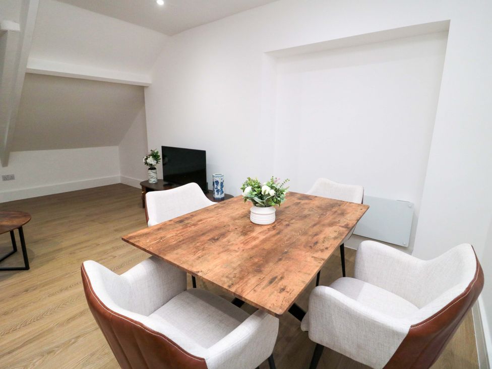 A dining room with a table and chairs at Beachwalk Villa 3 in Whitby