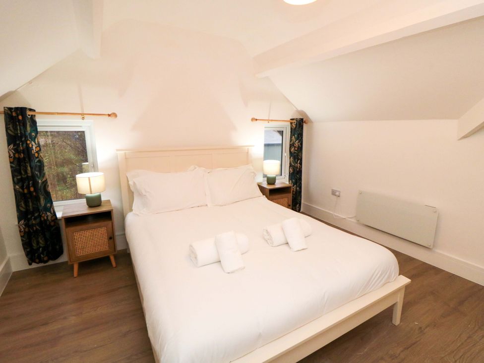 A bedroom with a bed and nightstand at Beachwalk Villa 3 Whitby