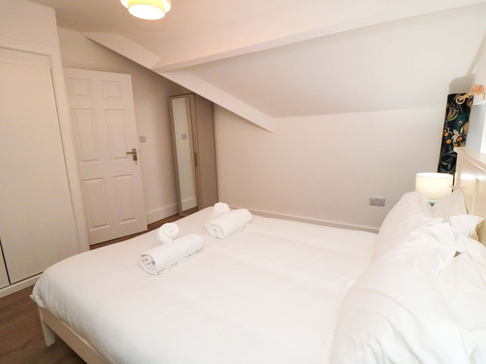 A bedroom with a bed and towels at Beachwalk Villa 3 in Whitby