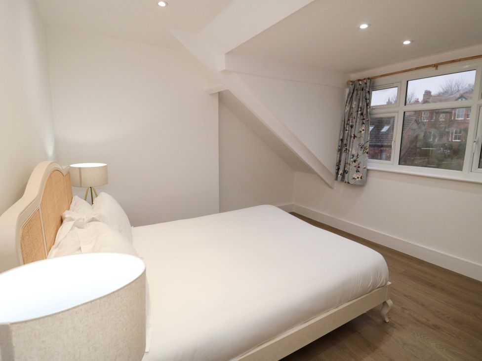 A bedroom with a bed and lamp at Beachwalk Villa 3 in Whitby