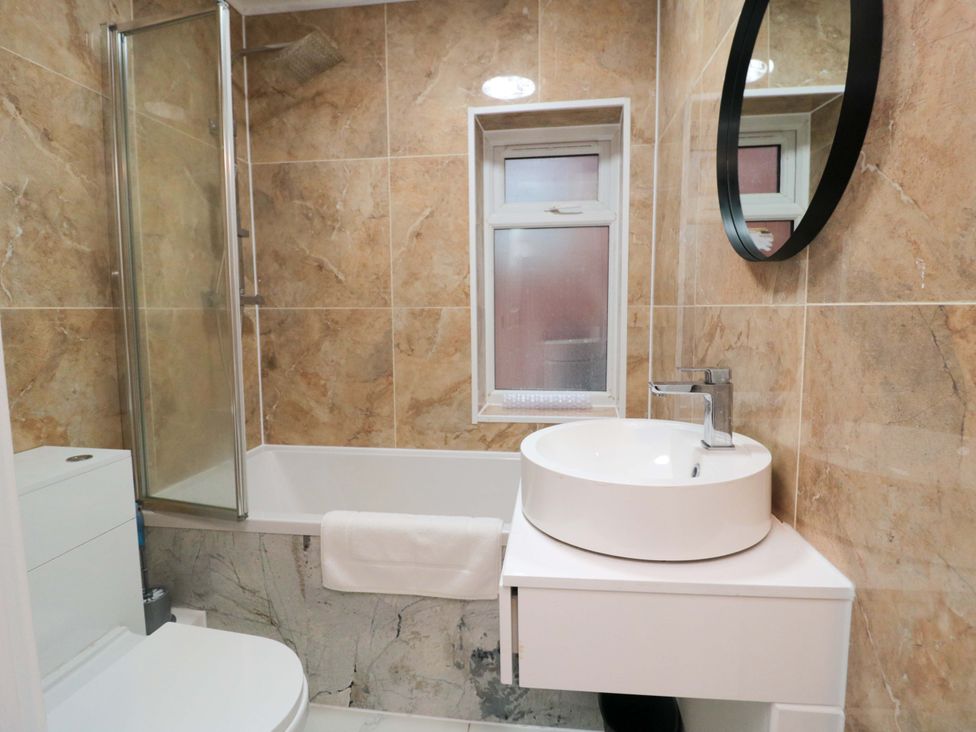 A bathroom with a sink and shower at Beachwalk Villa 3 in Whitby