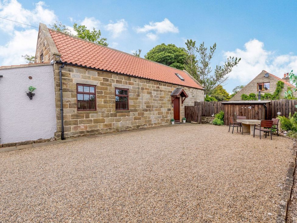 An outdoor area with a table and chairs at Lanes Barn in Whitby