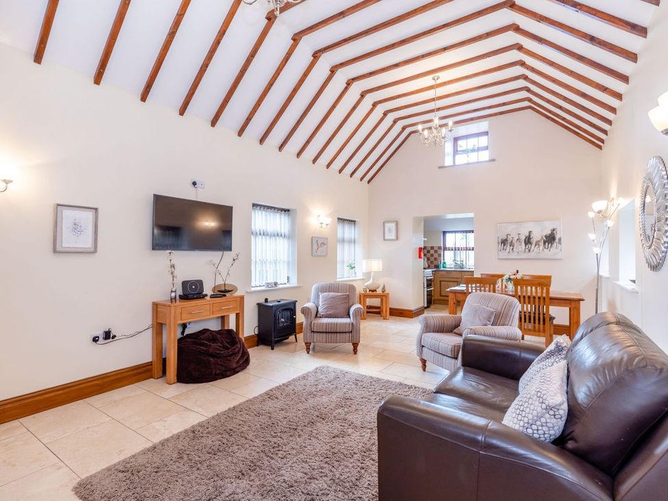 A living room with a television and seating at Lanes Barn in Whitby