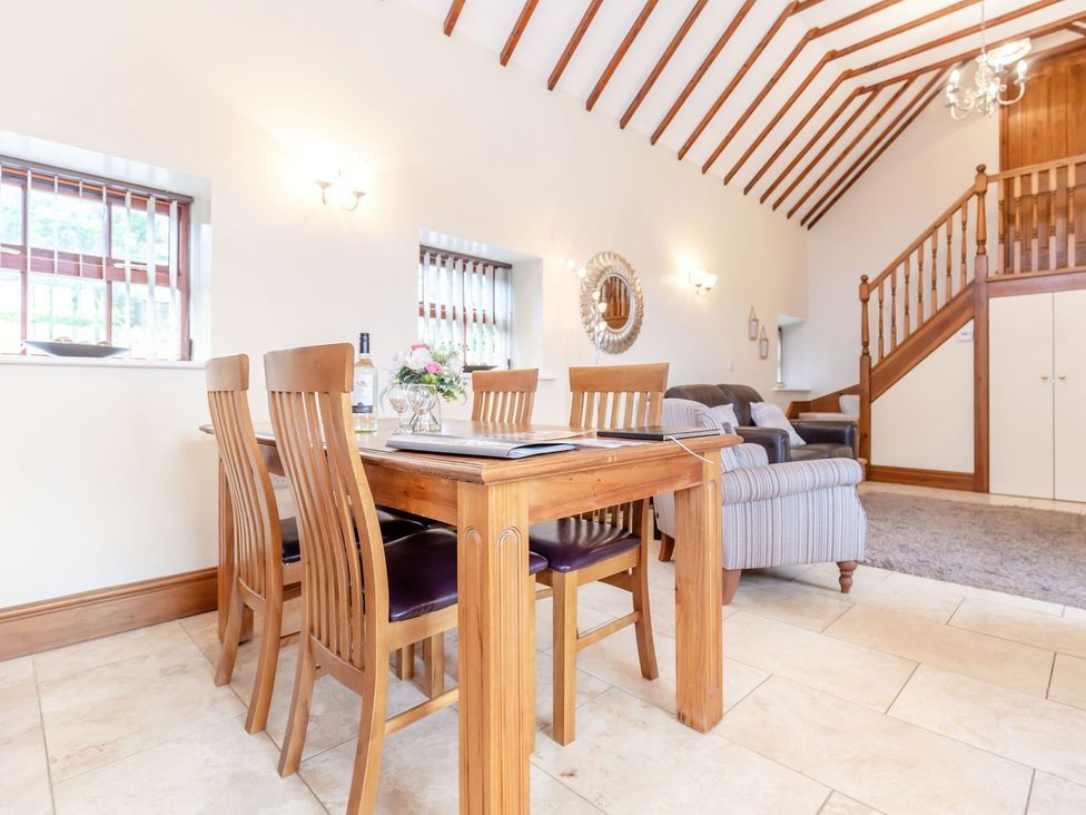A dining room with a table and chairs at Lanes Barn in Whitby