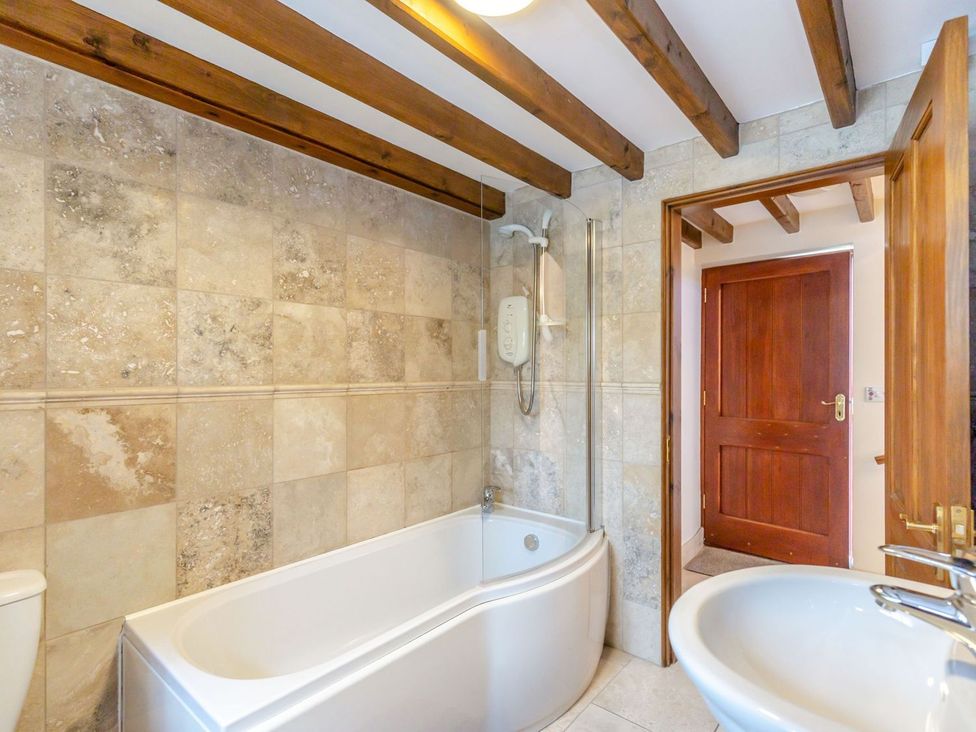 A bathroom with a bathtub, sink, and shower at Lanes Barn in Whitby