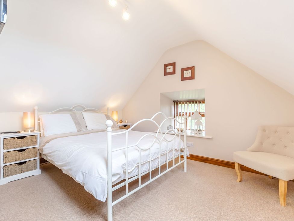 A bedroom with a bed and dresser at Lanes Barn in Whitby