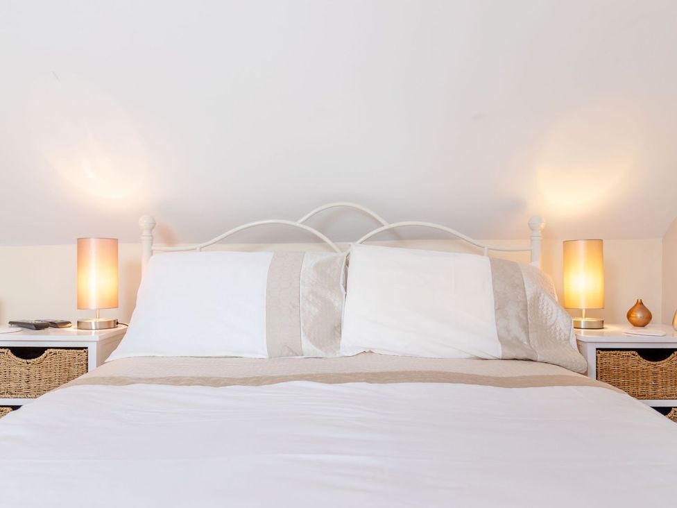 A bedroom with a bed and lamps on nightstands at Lanes Barn in Whitby