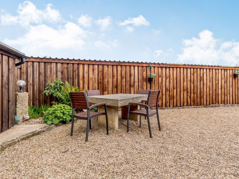 An outdoor area with a table and chairs at Lanes Barn in Whitby