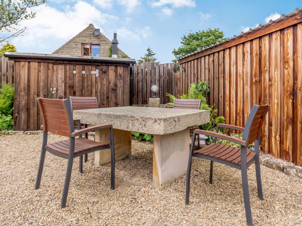 A table and chairs in a garden at Lanes Barn Whitby