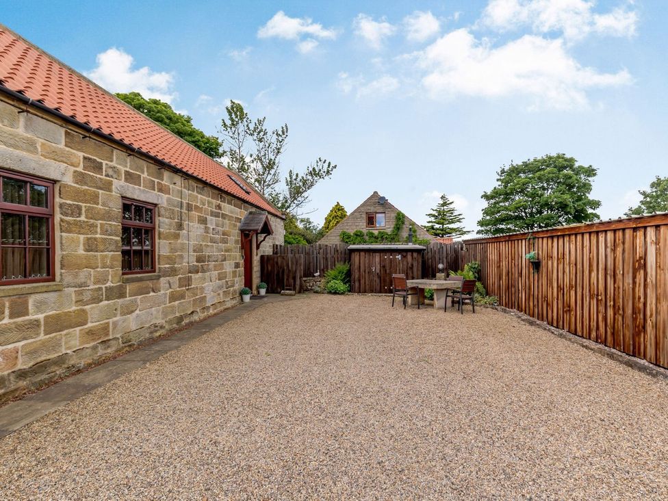An outdoor area with a table and chairs at Lanes Barn in Whitby