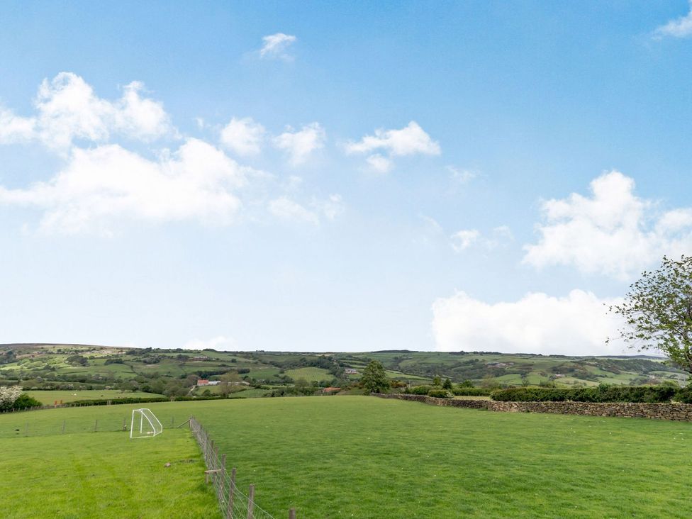 A field with a goalpost and trees at Lanes Barn in Whitby