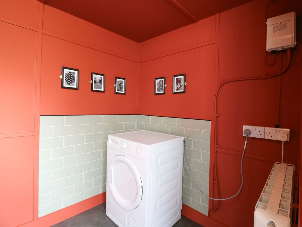 A laundry room with a washing machine at 1A Coastguard Cottages in Rye
