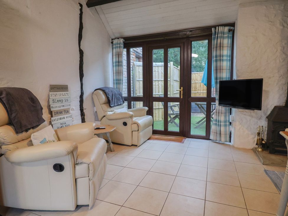 A living room with recliners and a television at Apple Cottage in Whitchurch Canonicorum