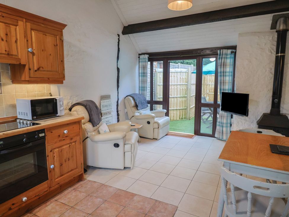 A kitchen with a dining table and chairs at Apple Cottage in Whitchurch Canonicorum